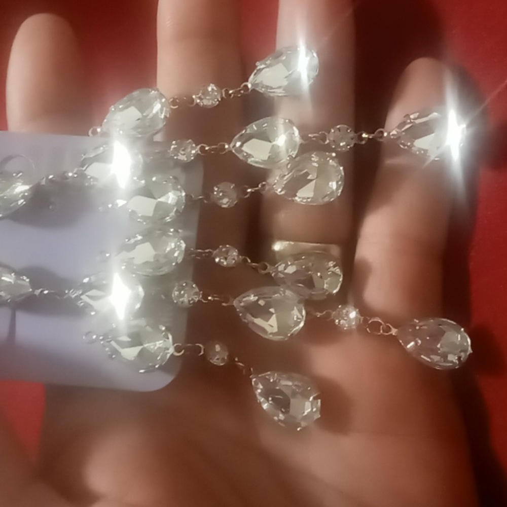 Clair's tear drop crystal chandelier crystal earrings in a gold tone setting.